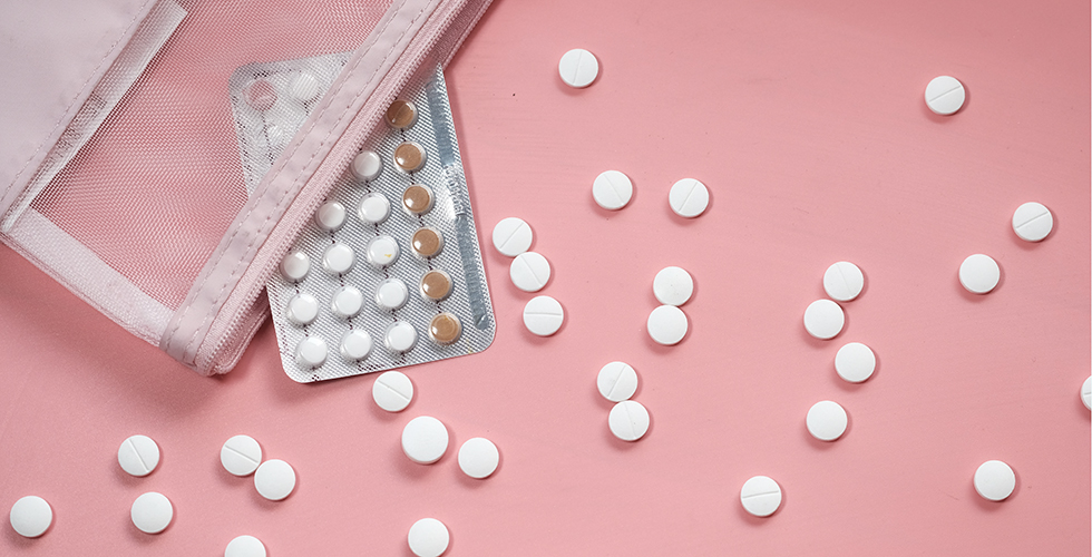 Birth Control Pills On Pink Background, Top View .